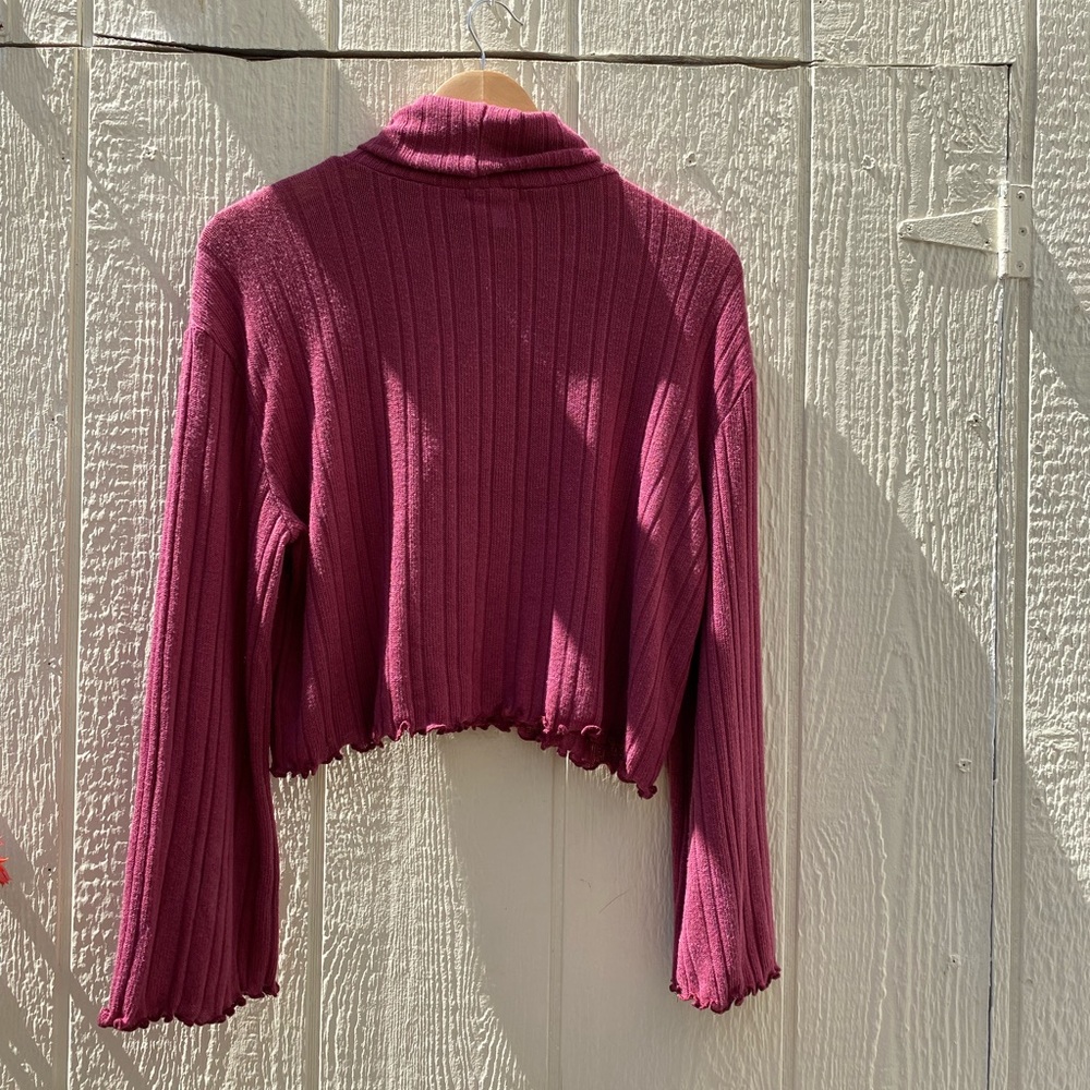 Rose color sweater with flared sleeves